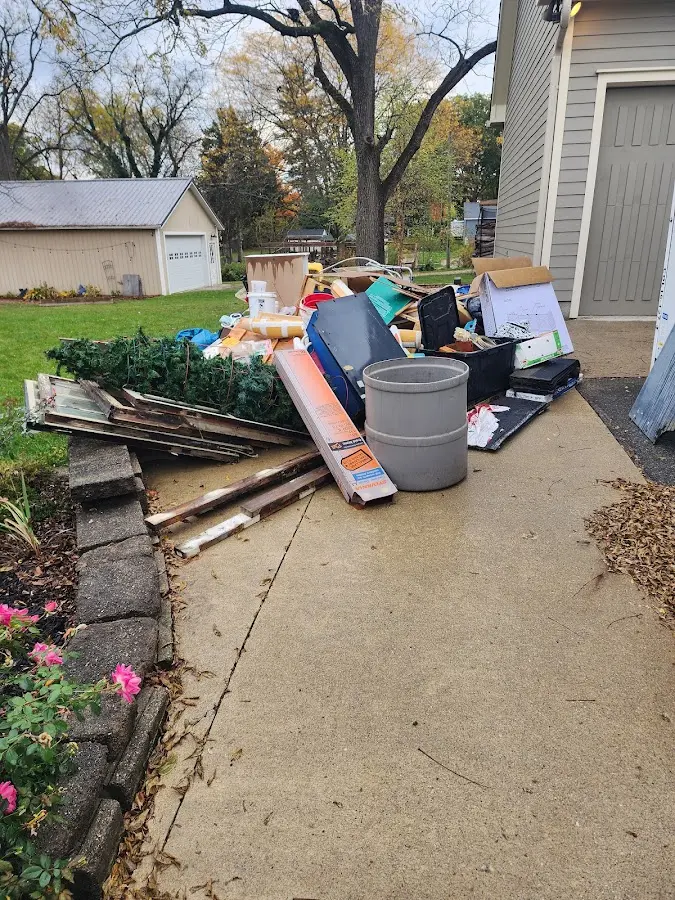 Dumpster being loaded with debris for 3 Yard Dumpster Rental in Kitty Hawk